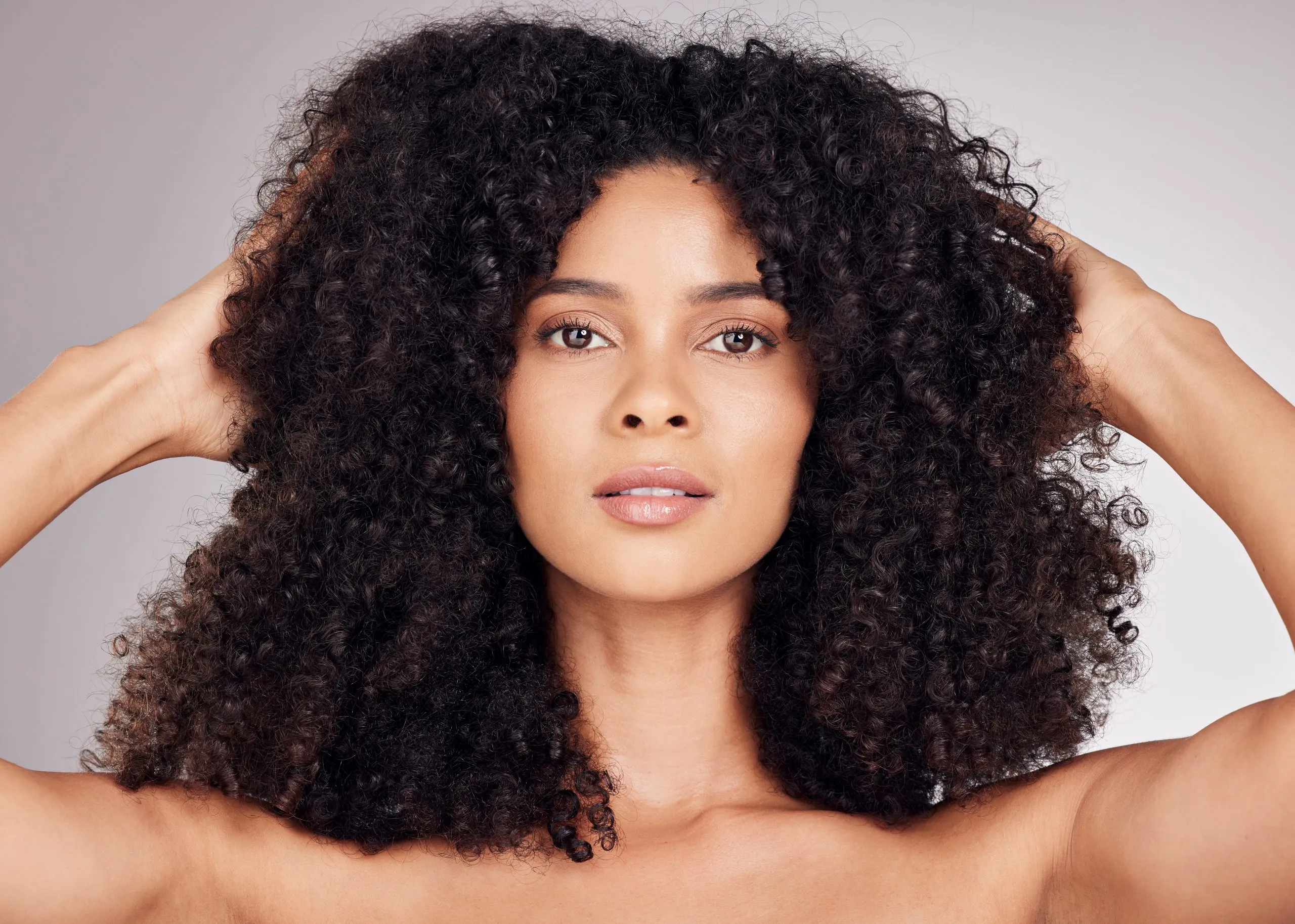 Natural-looking human hair extensions with high-quality curly texture.